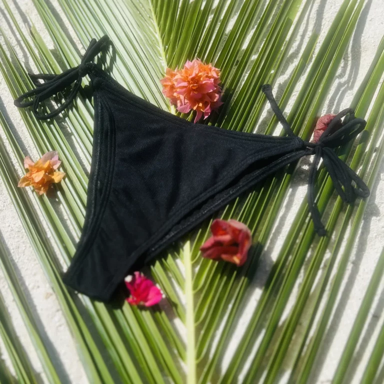 Black mid-rise Chloe Bikini Bottom with adjustable tie sides for a flawless fit.