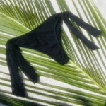 Chic black Ava Bottom bikini with adjustable ties for versatile beach style and tanning.
