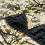Elegant black Kira triangle bikini top with adjustable ties for a perfect fit.