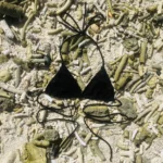 Elegant black Kira triangle bikini top with adjustable ties for perfect fit and tanning.